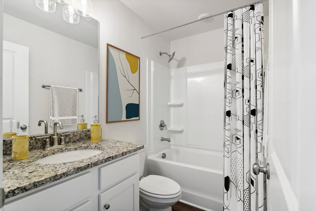 a bathroom with a shower and a sink and a toilet