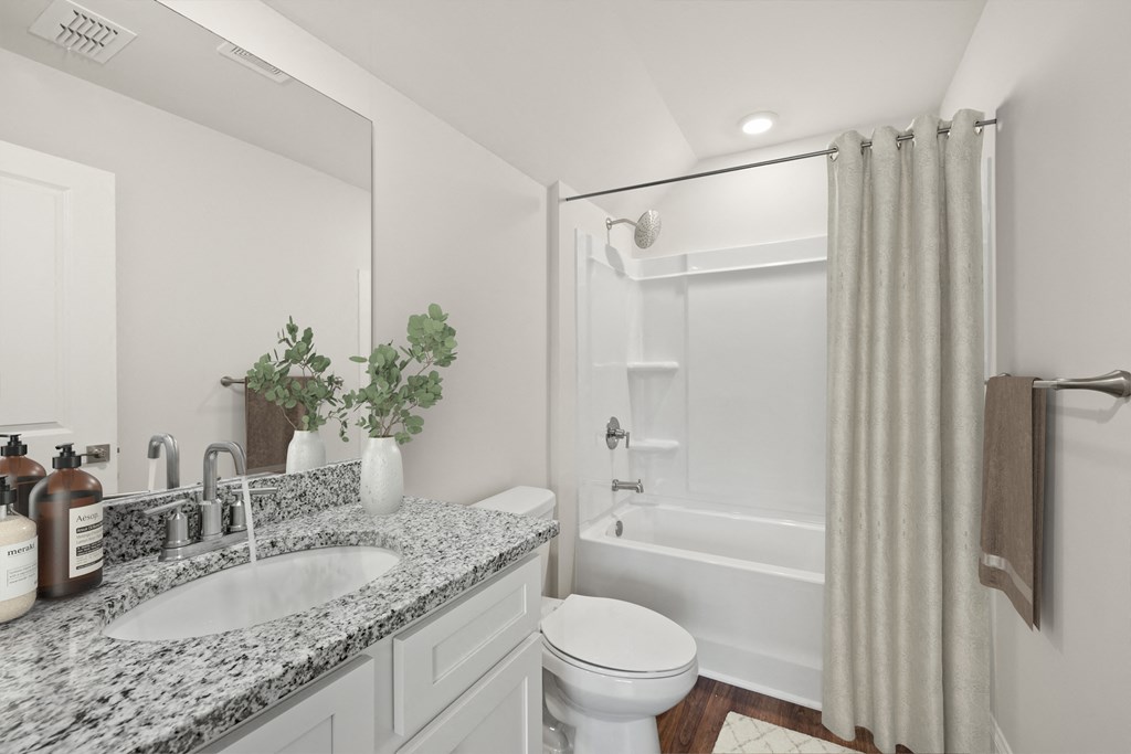 Secondary suite bathroom with a tub and shower combination