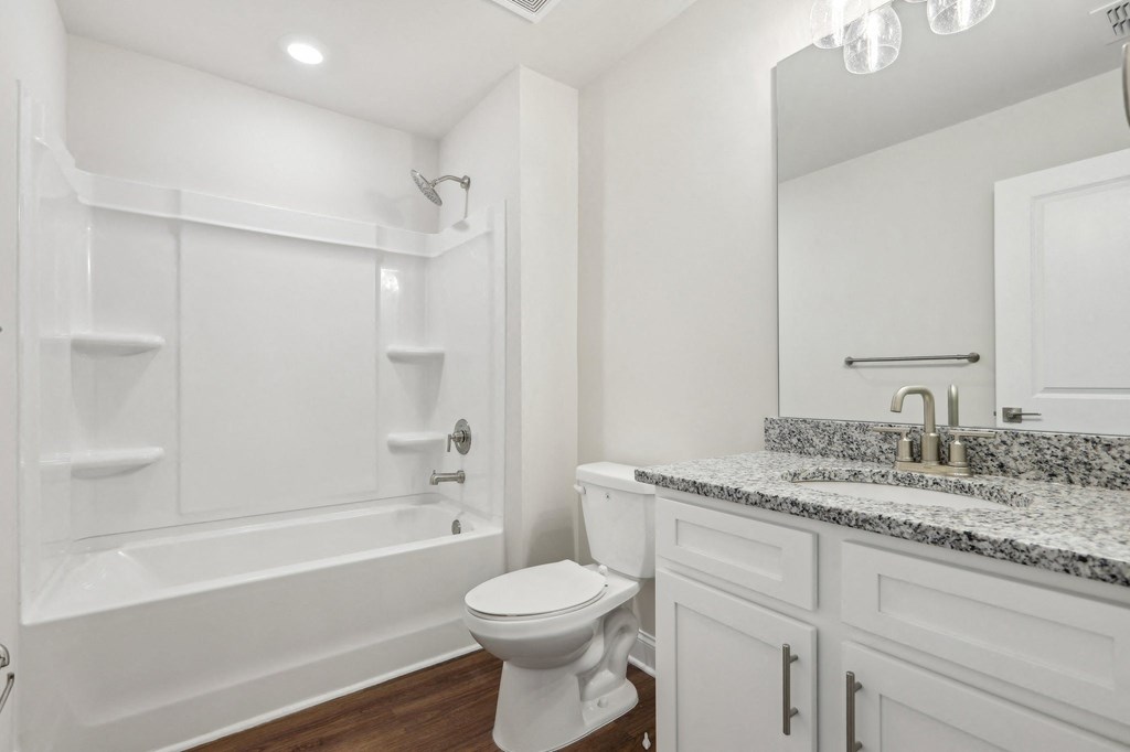 Secondary bathroom with tub shower and single vanity.