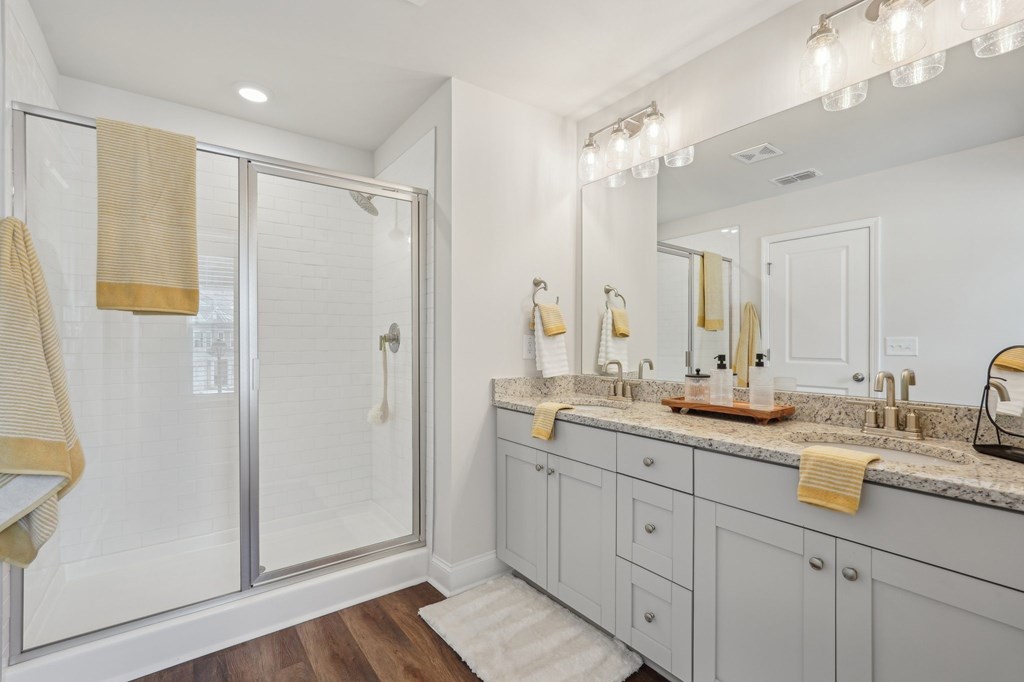 Primary bathroom with double vanity, and walk-in shower.