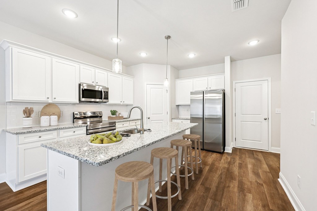 A view of the spacious kitchen and stainless steel appliances