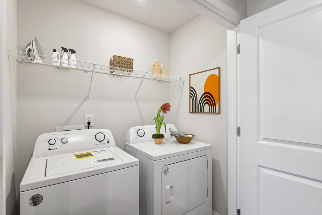 a small laundry room with a washer and dryer and a sink