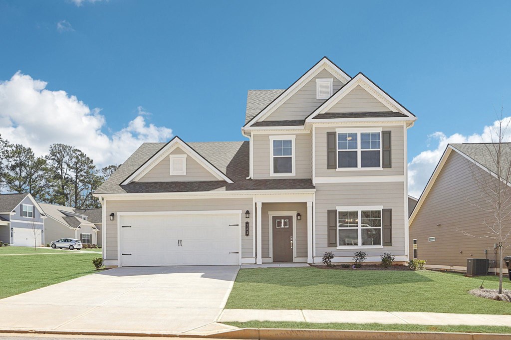 Exterior of the Wilmot, two story home with a private driveway and attached garage.