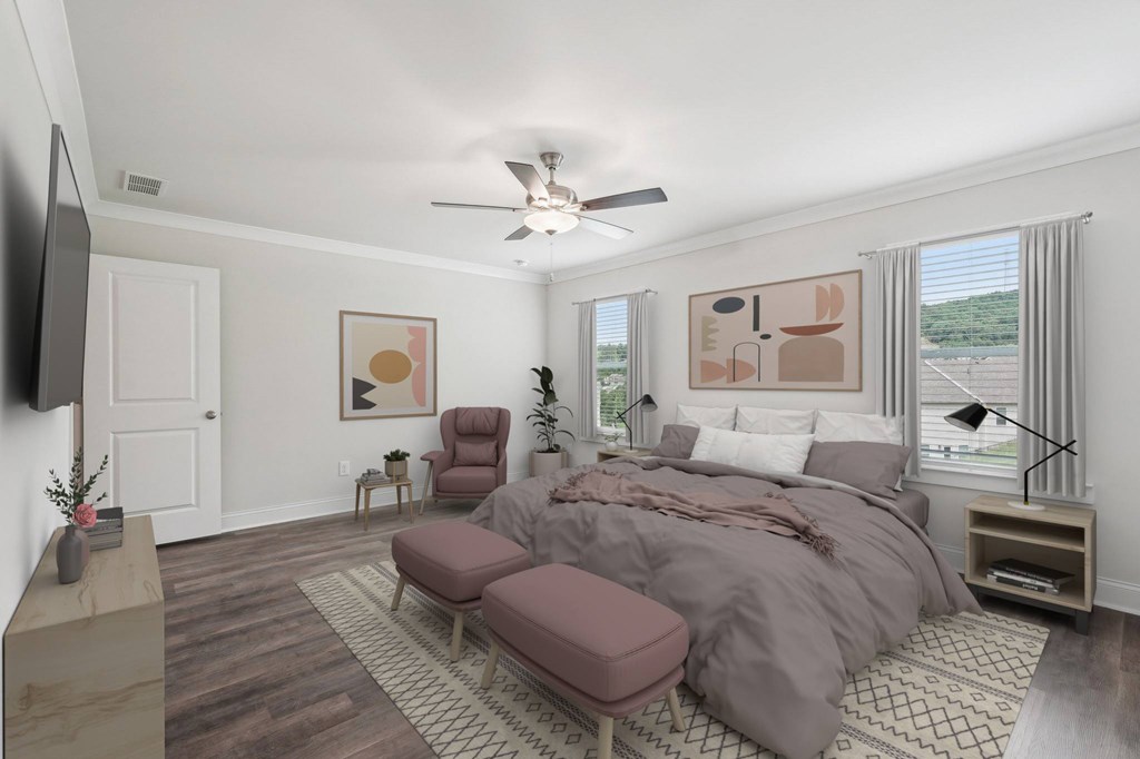 Primary bedroom with king size bed and large window letting in nice natural light.