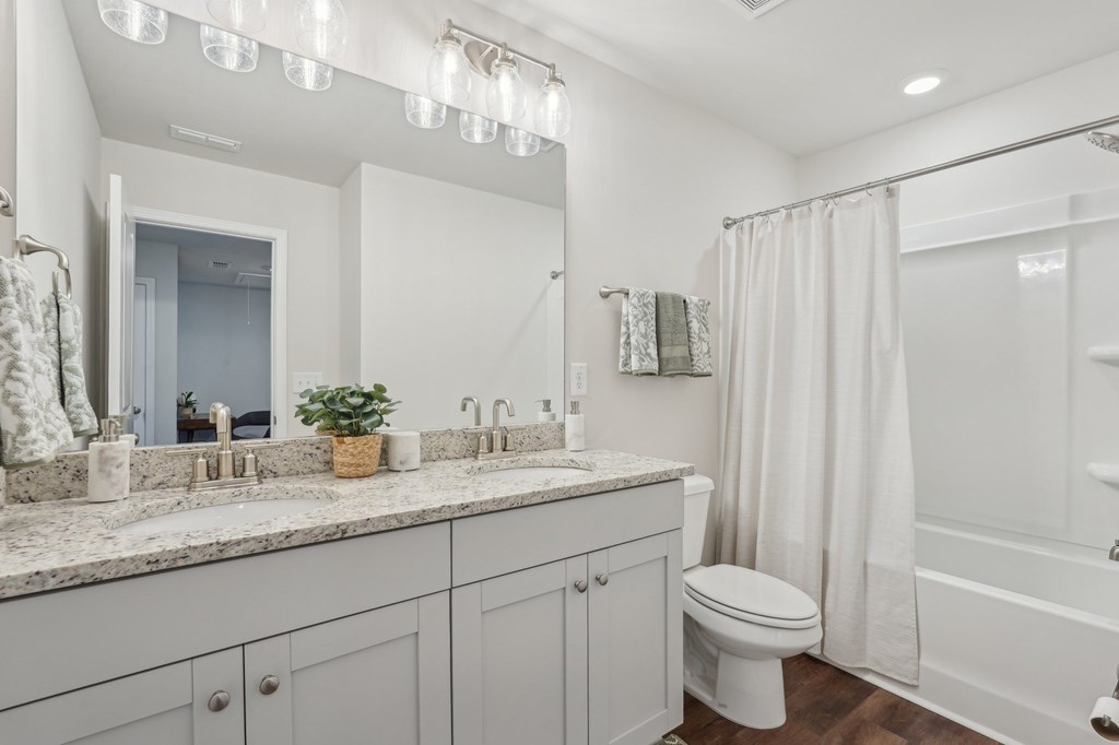 Secondary suite bathroom with a tub and shower combination