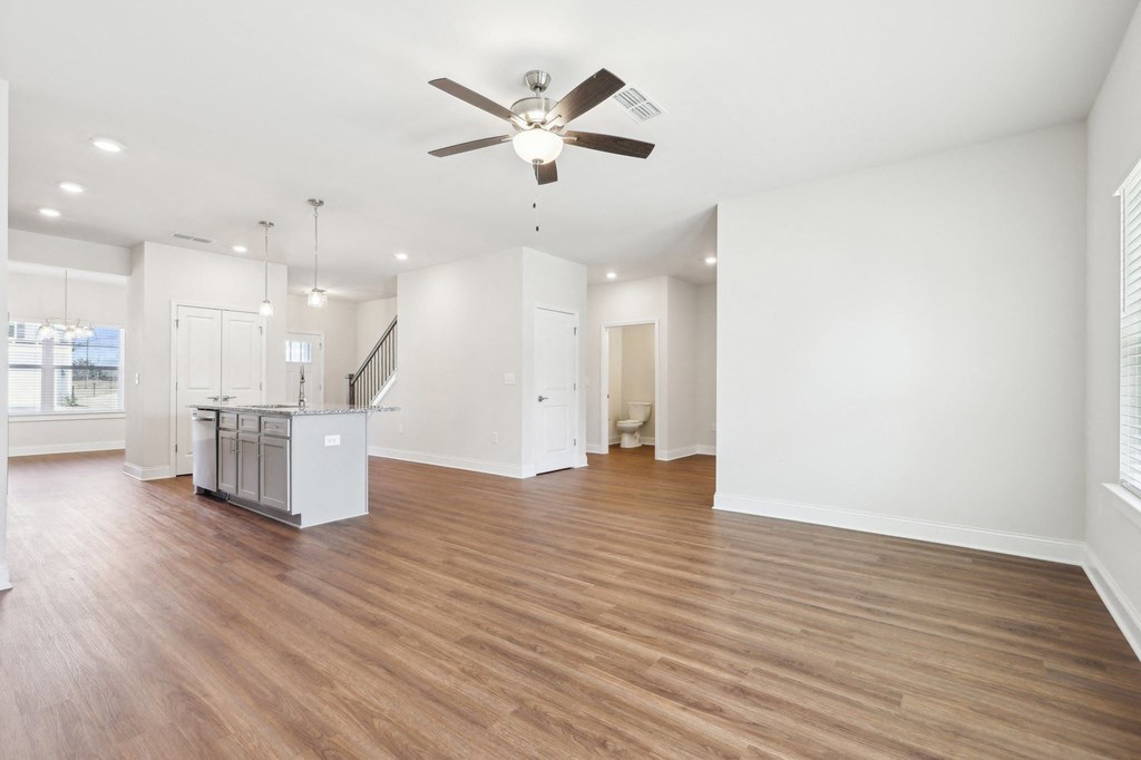 Open kitchen featuring a refrigerator, sink, and ceiling fan.
