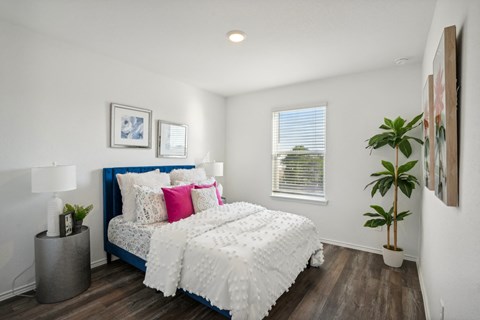 A bedroom with a white bed and a blue headboard.