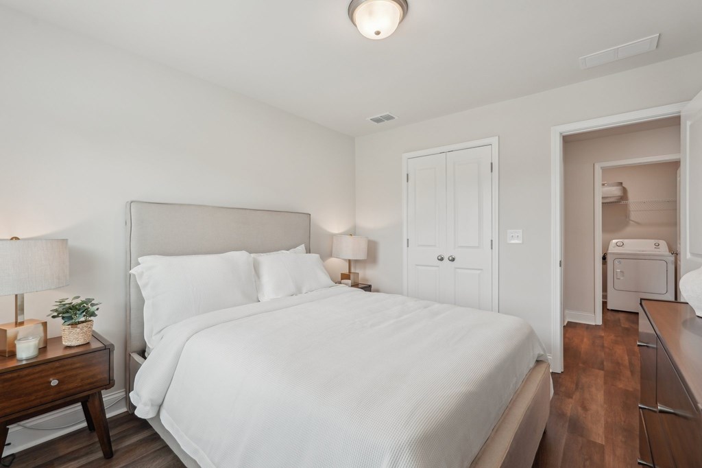 Secondary bedroom with queen size bed and large window letting in a ton of natural light.