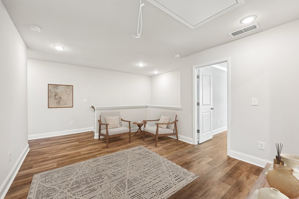 Cozy upstairs loft featuring two stylish chairs—perfect for relaxing or unwinding with a good book.