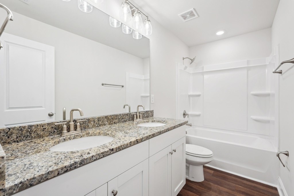 Secondary bathroom with tub shower and double vanity.
