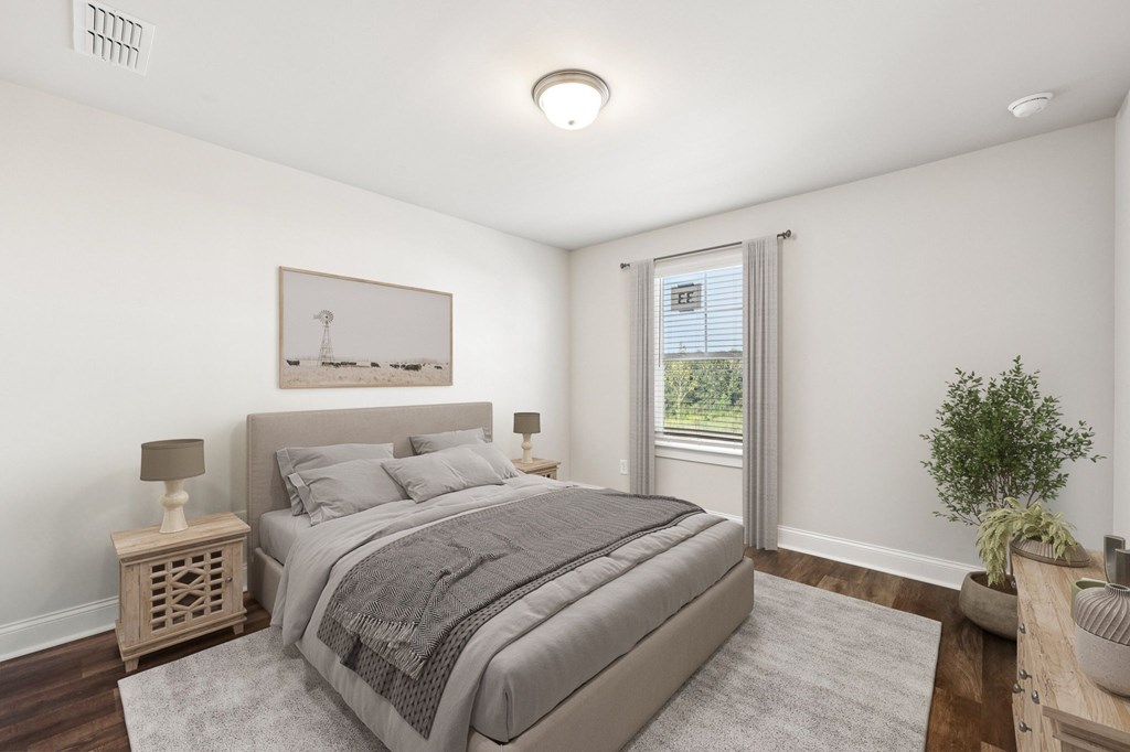 Secondary bedroom with queen size bed and large window letting in a ton of natural light.