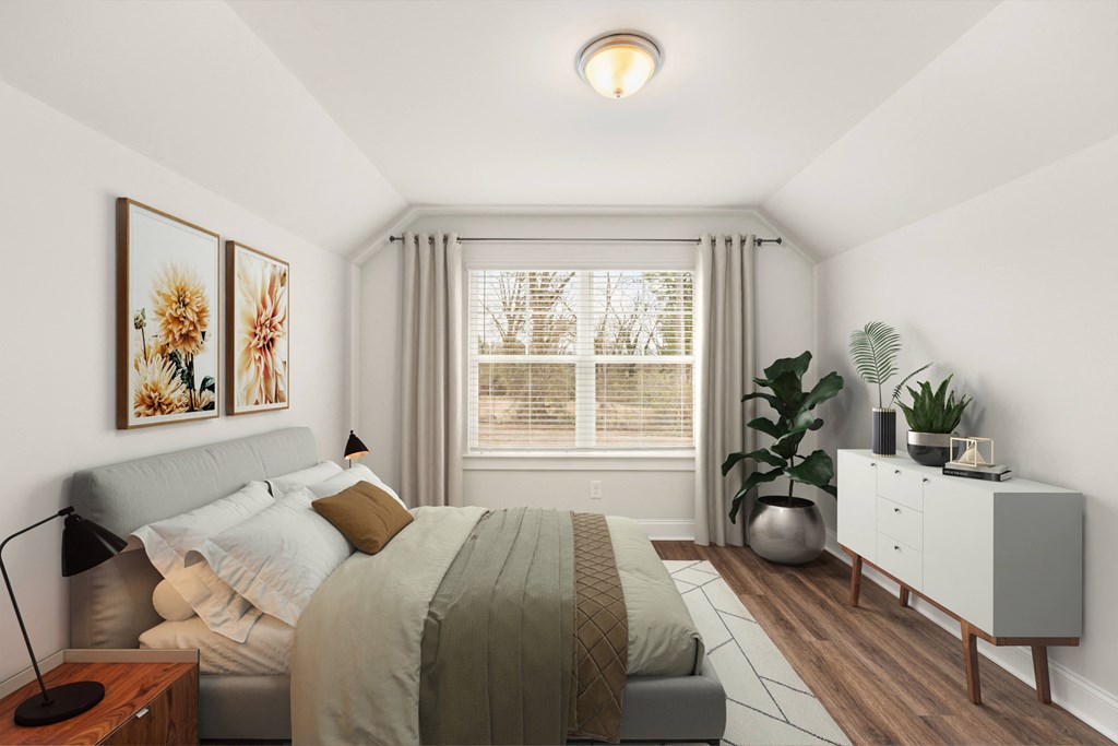 Secondary bedroom with queen size bed and large window letting in a ton of natural light.