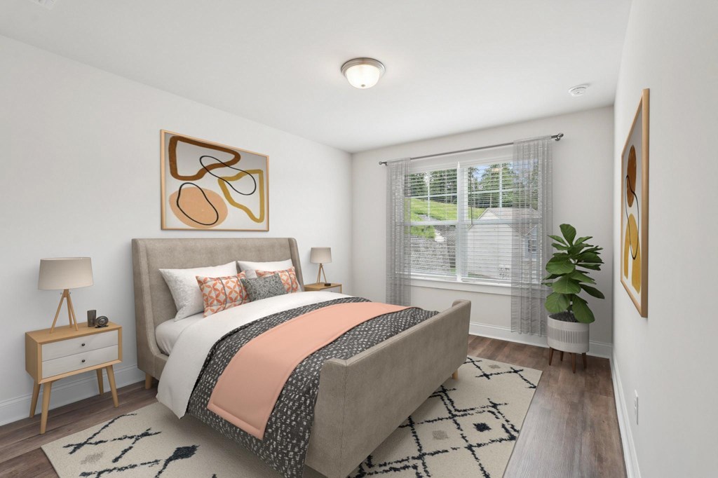 Secondary bedroom with queen size bed and large window letting in a ton of natural light.
