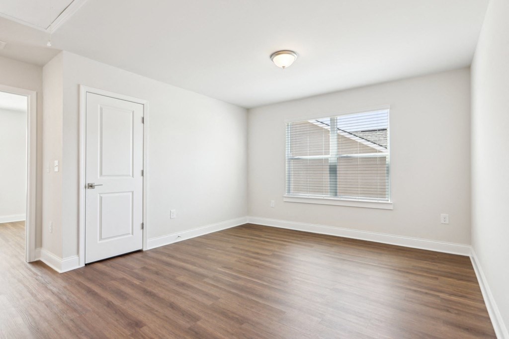 Bright room with a window and classic white door.
