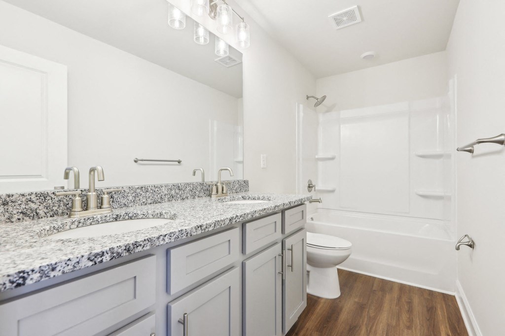 Secondary bathroom with tub shower and single vanity.