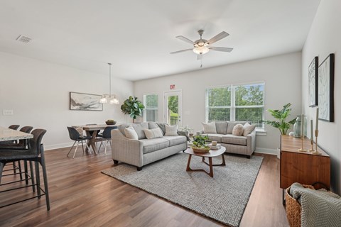 A living room with a dining table and a couch.