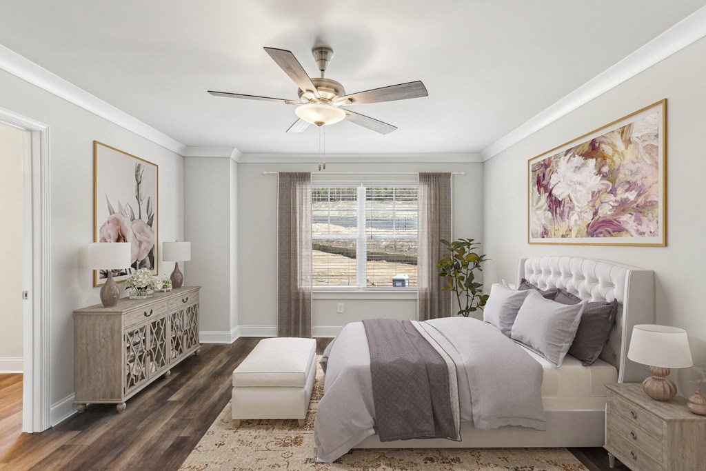 a bedroom with a bed and a ceiling fan