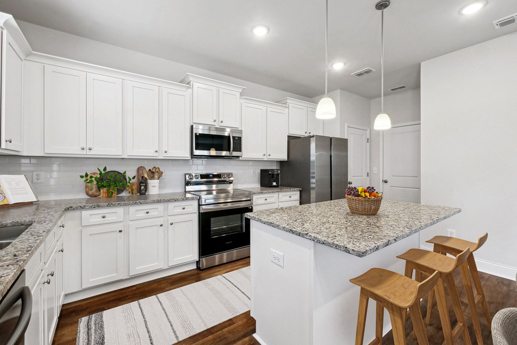 Spacious kitchen with an island, ample storage, and stainless steel appliances.