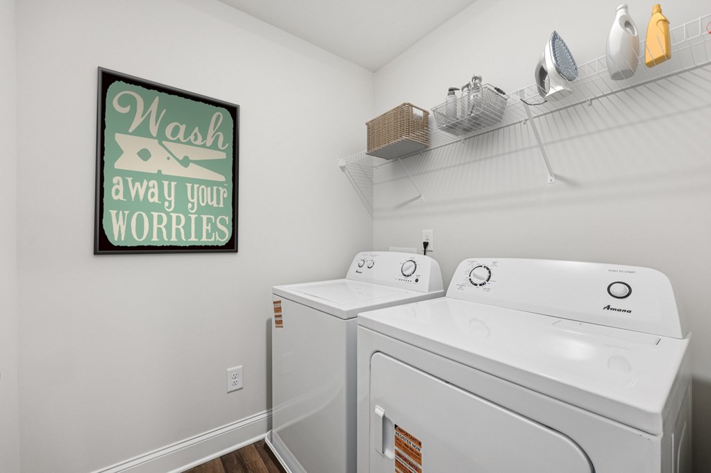 A spacious laundry room complete with full-size washer and dryer.