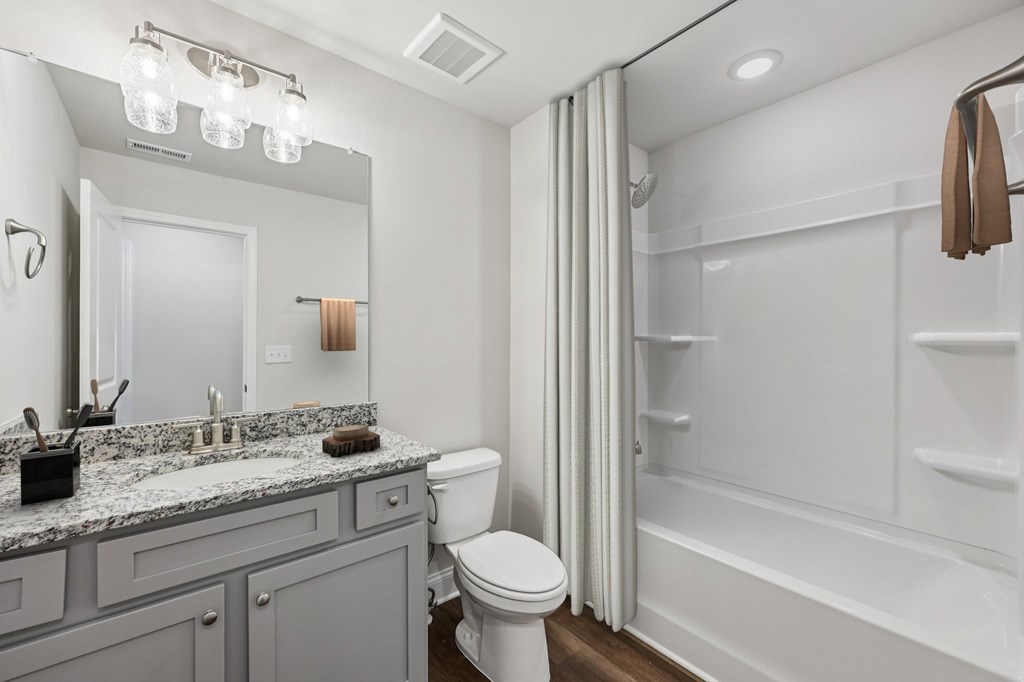 Secondary suite bathroom with a tub and shower combination