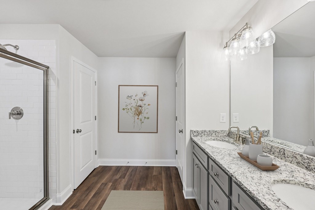 A luxurious primary bathroom with a double vanity and spacious walk-in shower.