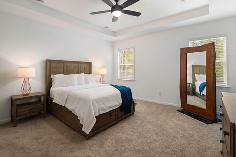 Primary Bedroom with king size bed and large window letting in nice natural light.