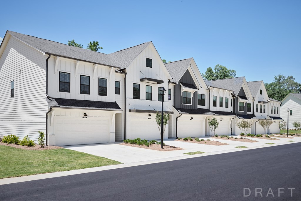 a row of white houses with white doors and black shutters
