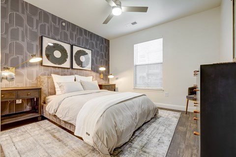 Large bedroom, natural light, king size bed, two night stands and dresser