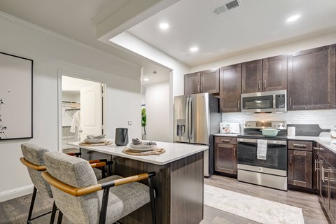 Stunning kitchen with beautiful white granite counter tops. Stainless steel appliances.