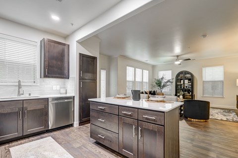 Spacious open living room with built in fireplace. Lots of natural light, plush carpet and ceiling fan.