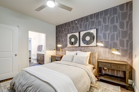 Stunning large bedroom, with queen size bed two nightstands and a large dresser and ceiling fan