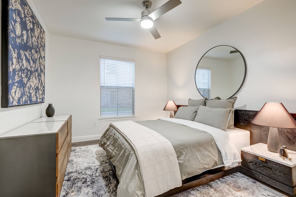 Large bedroom, natural light, king size bed, two night stands and dresser