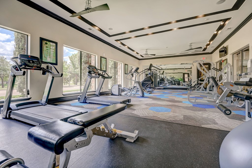 a fitness center with treadmills and other exercise equipment