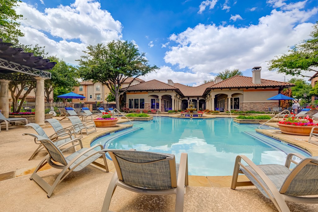 Swimming pool in Las Colinas with outdoor seating and grilling stations