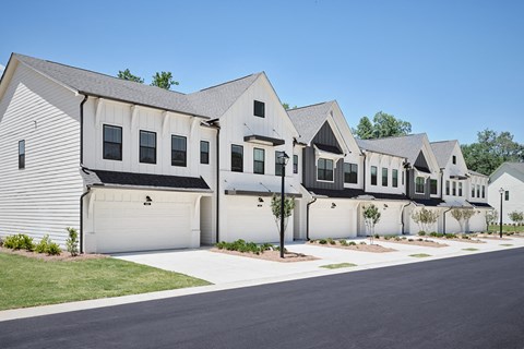 Exterior shot of the two townhomes with private driveways and attached garages.