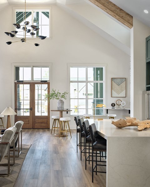 Inviting clubhouse space bathed in natural light with modern seating throughout.