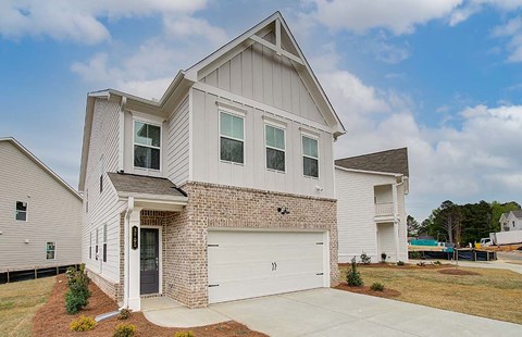 Exterior of the Florance, two story home with a private driveway and attached garage.