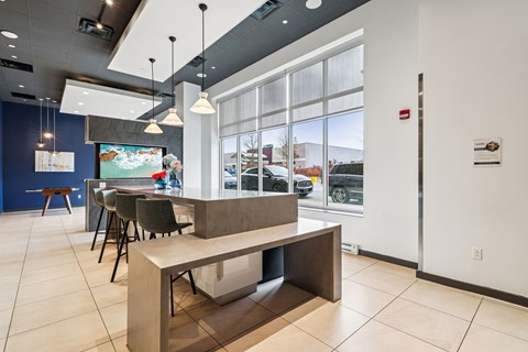 A modern dining area with a long table and chairs.
