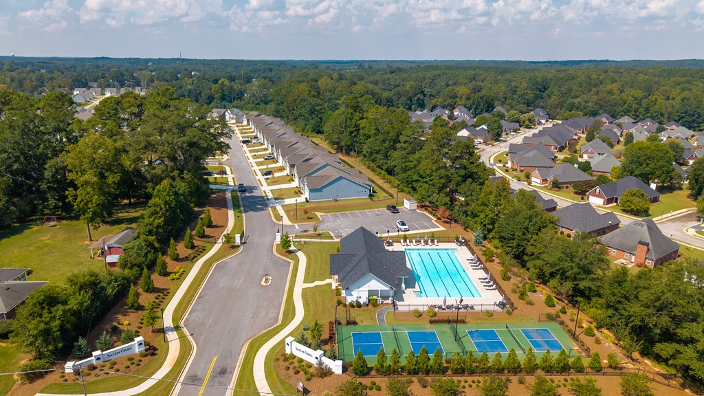 Bird’s-eye view capturing the clubhouse, community amenities, and surrounding homes.