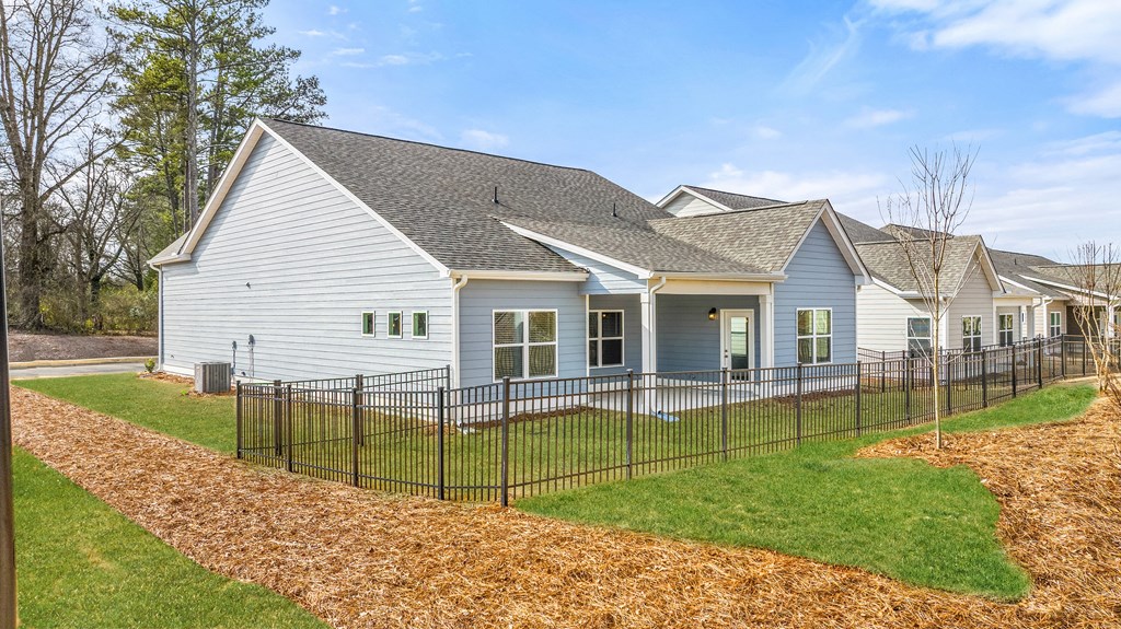a white house with a black fence in front of it