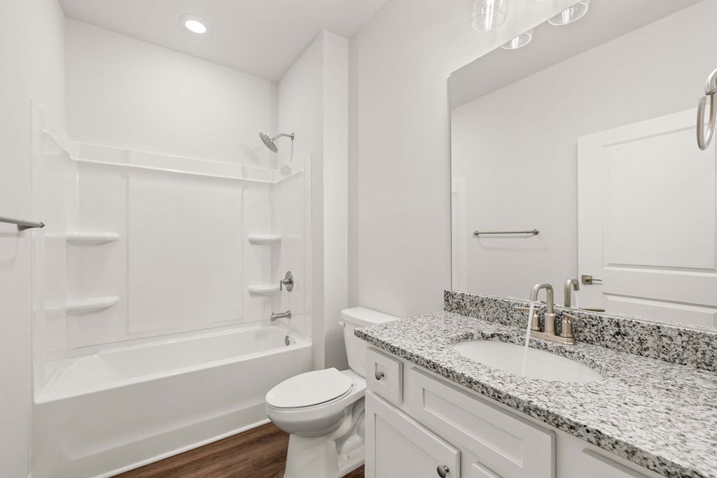 a bathroom with a sink toilet and a bath tub