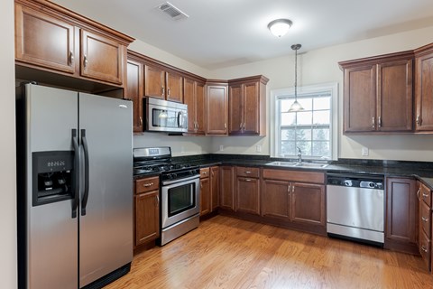 A kitchen with wooden cabinets and stainless steel appliances.