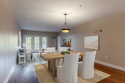 A dining room with a wooden table and chairs.