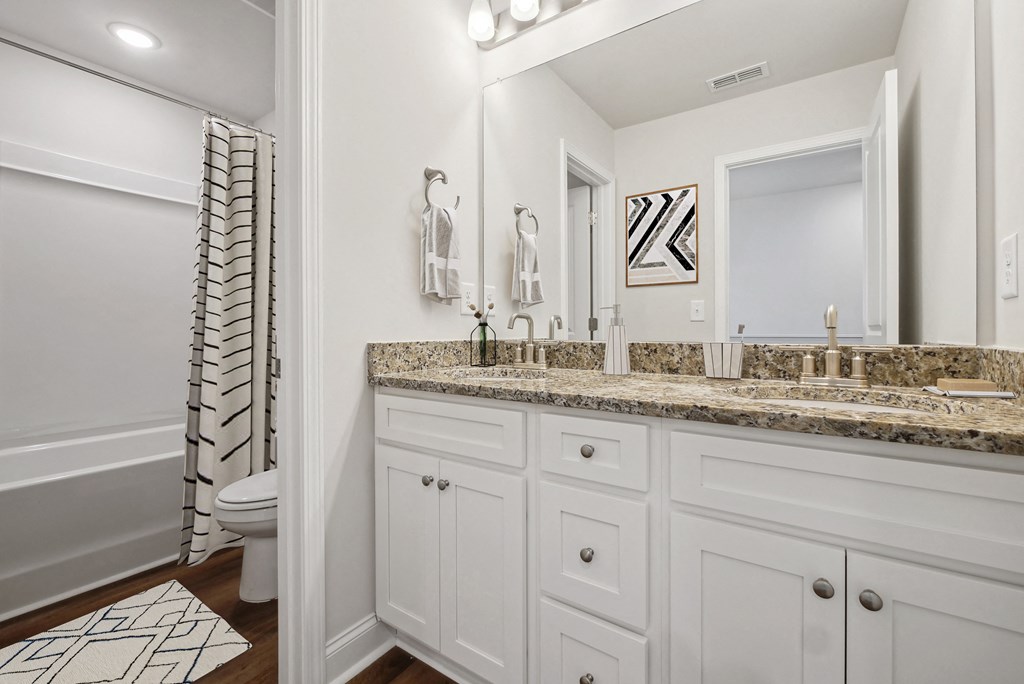 Secondary suite bathroom with a tub and shower combination