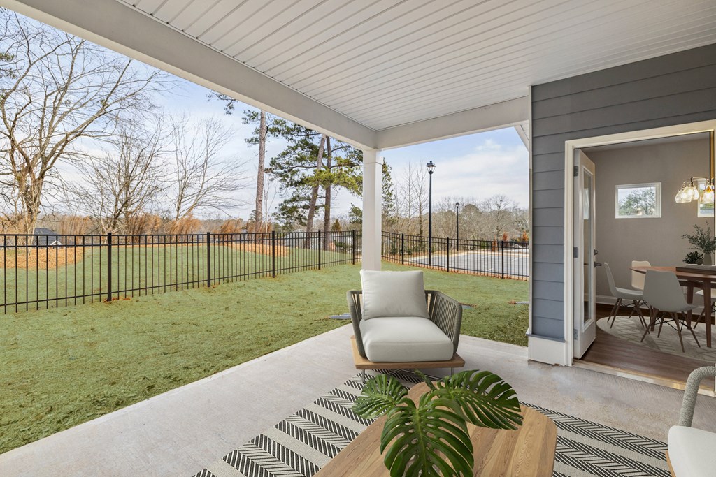 Covered back patio with fenced in yard.