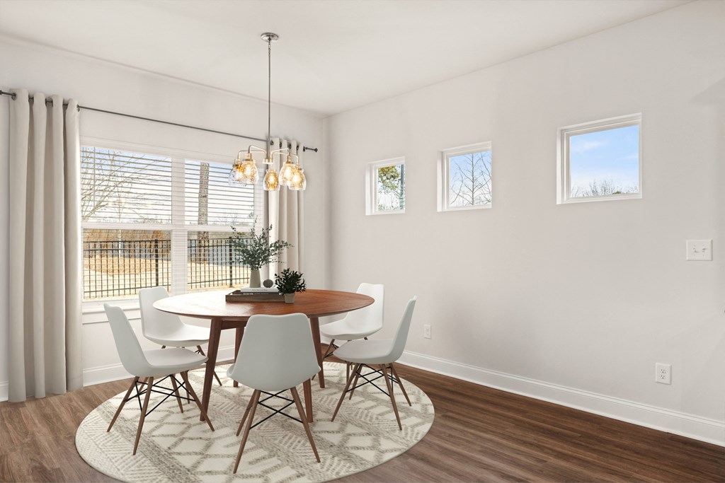 a dining room with a table and chairs and a window