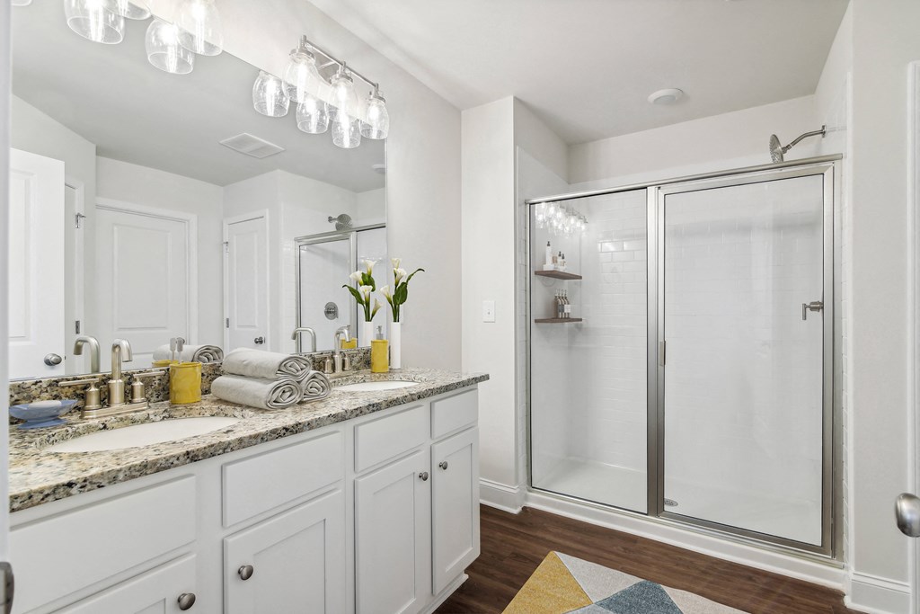 a white bathroom with a shower and a sink