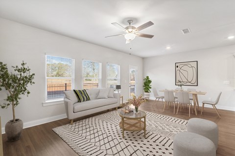 a living room with a couch and a ceiling fan