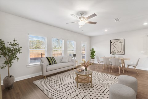 a living room with a couch and a ceiling fan