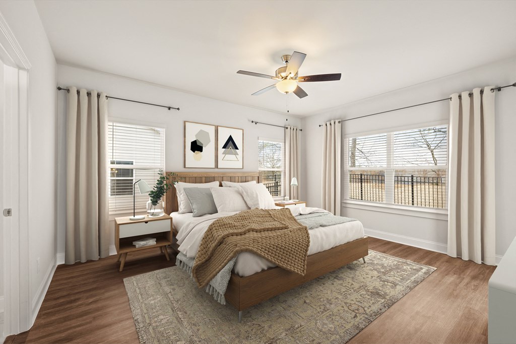 a bedroom with a bed and a ceiling fan